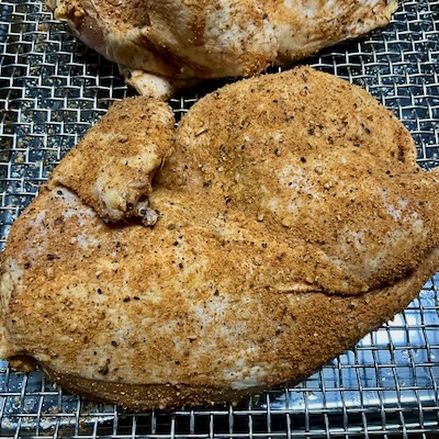 picture of raw whole chicken rubbed with right stuff